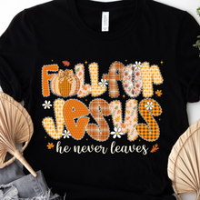 Load image into Gallery viewer, Bella Canvas Black t-shirt with &#39;Fall for Jesus he never leaves&#39; text and pumpkin patchwork style design on a white background.