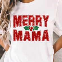 Load image into Gallery viewer, White t-shirt with 'Merry Mama' text and holly design worn by a person.