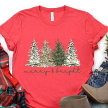 Load image into Gallery viewer, Red t-shirt with Christmas tree design and 'merry &amp; bright' text, surrounded by plaid shirt.
