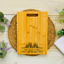 Load image into Gallery viewer, Bamboo cutting board with engraved name with pine tree border