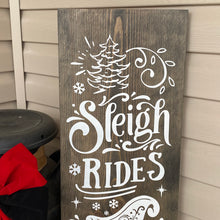 Load image into Gallery viewer, Wooden sign with &#39;Sleigh Rides&#39; text and Christmas-themed decorations on a wooden background.