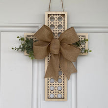 Load image into Gallery viewer, Decorative cross wall hanging with a burlap bow and greenery.