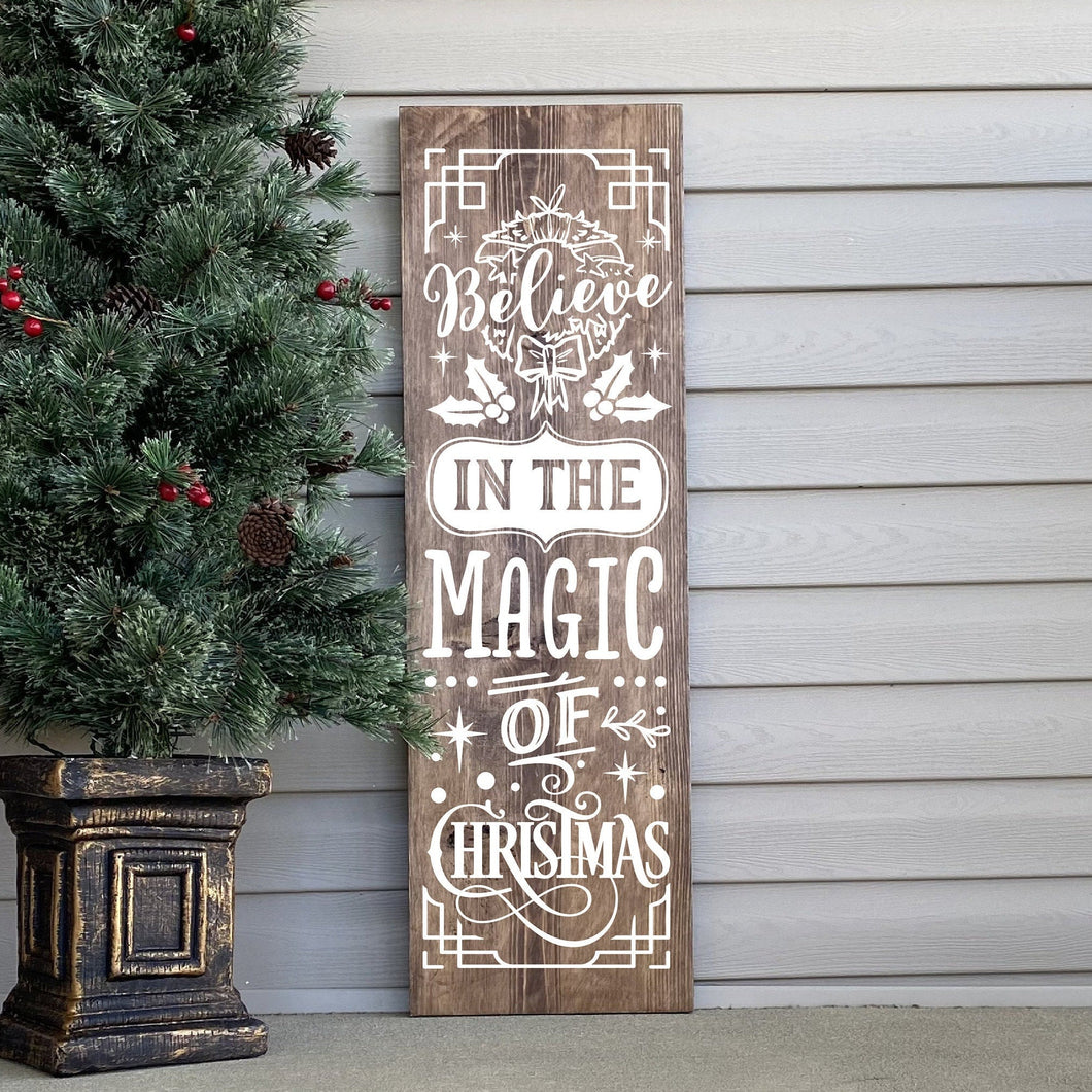 Wooden Christmas sign with decorative text Believe in the Magic of Christmas.