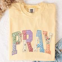 Load image into Gallery viewer, Comfort Colors Butter colored t shirt with the word "Pray" in a faux qullt pattern.