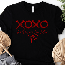 Load image into Gallery viewer,  Black Christian T-shirt with red crossed nails and crowns of thorns forming XOXO above “The Original Love Letters” lettering.